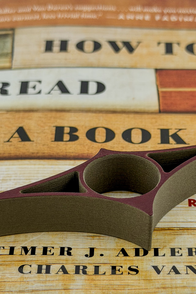 A Reading Ray sitting on top of a closed book.